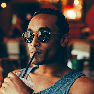 man with sunglasses drinking