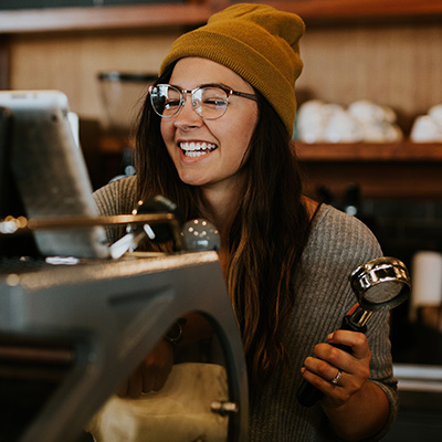 girl smiling while preparing coffee 