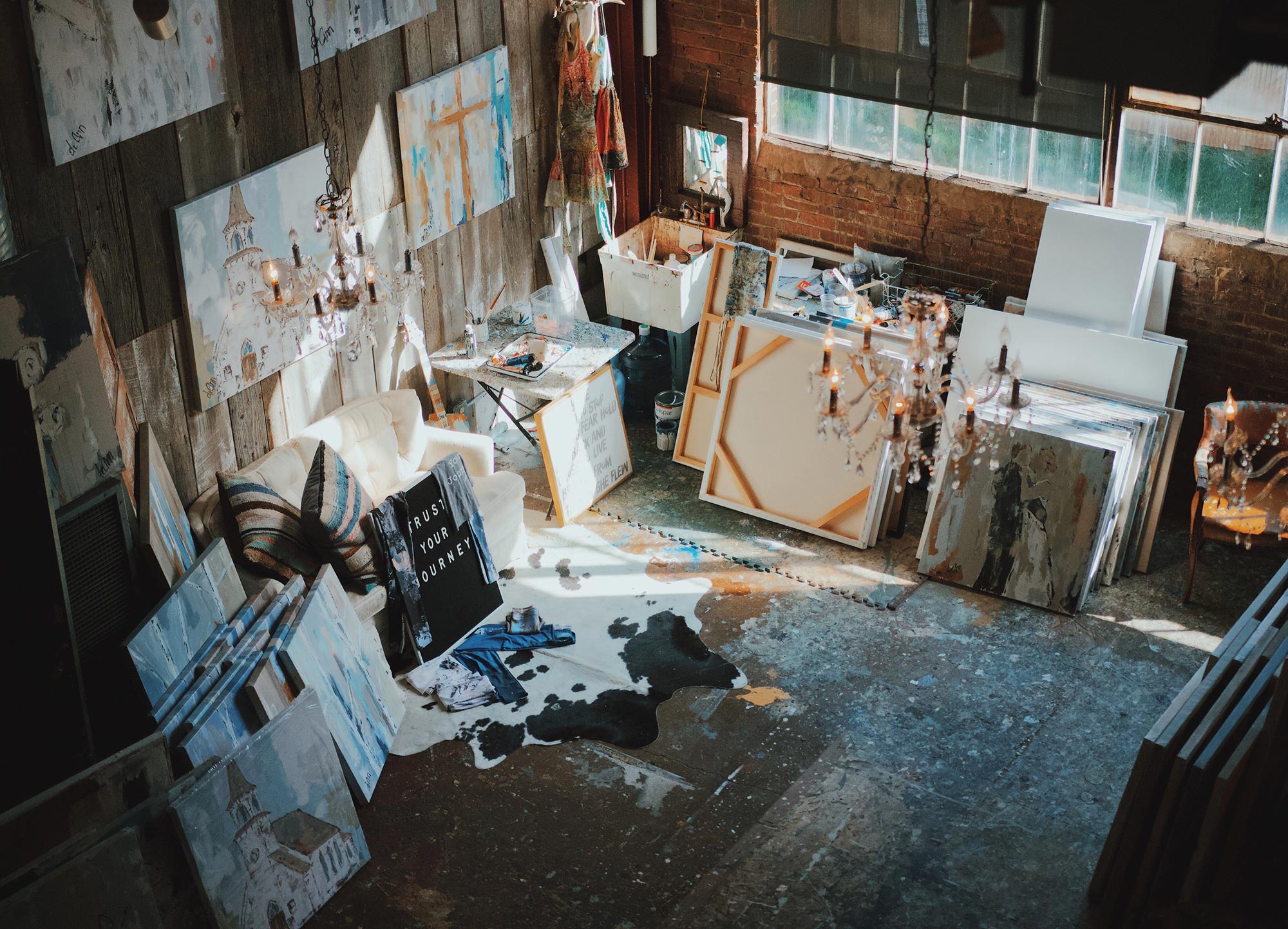 Canvases and paintings in a rustic art studio