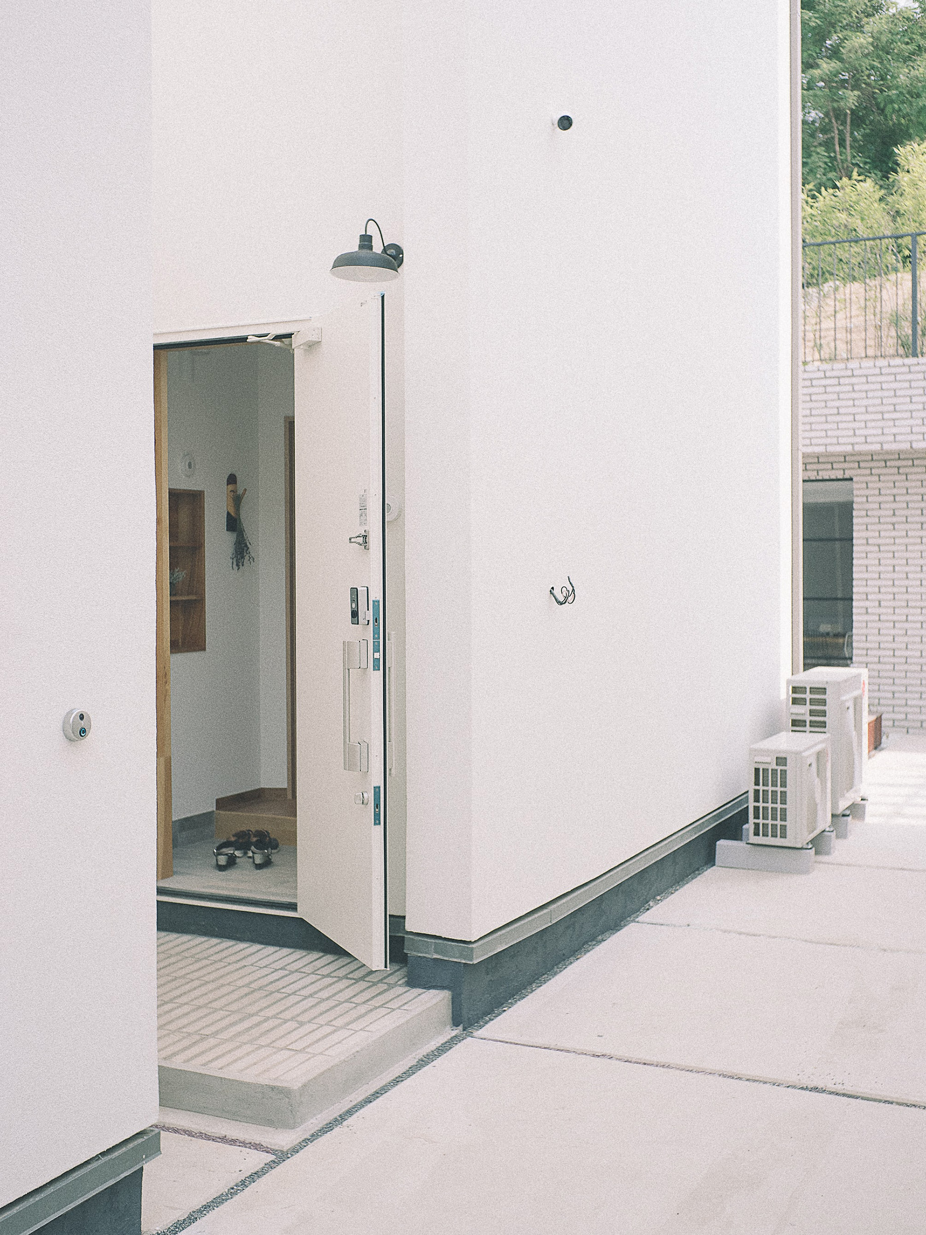Modern white concrete building with open door